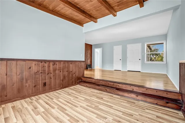a view of a room with wooden floor and stairs
