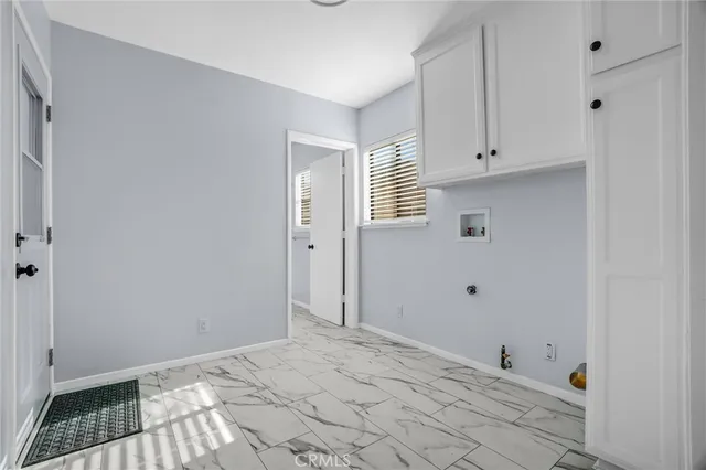a view of a kitchen with white cabinets