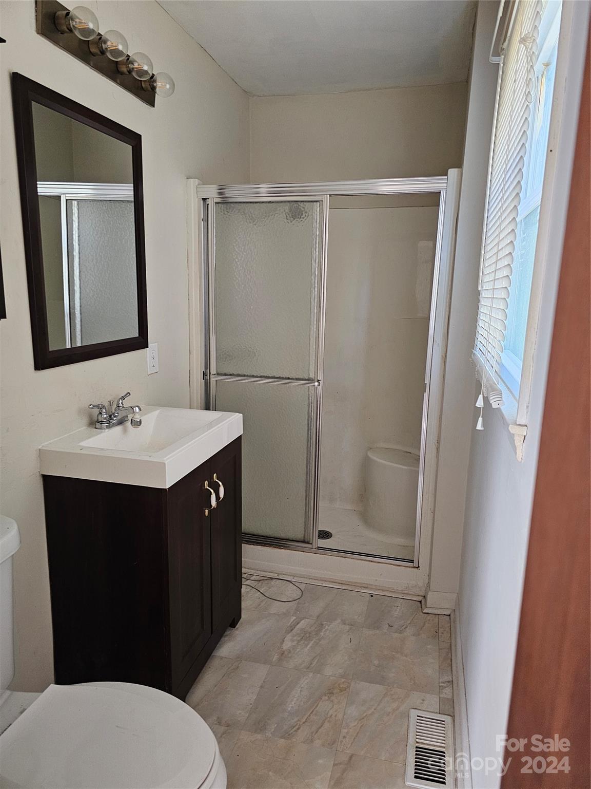 2702 University Drive Lancaster, SC 29720 - Photo 16 of 17 a bathroom with a sink vanity toilet and shower