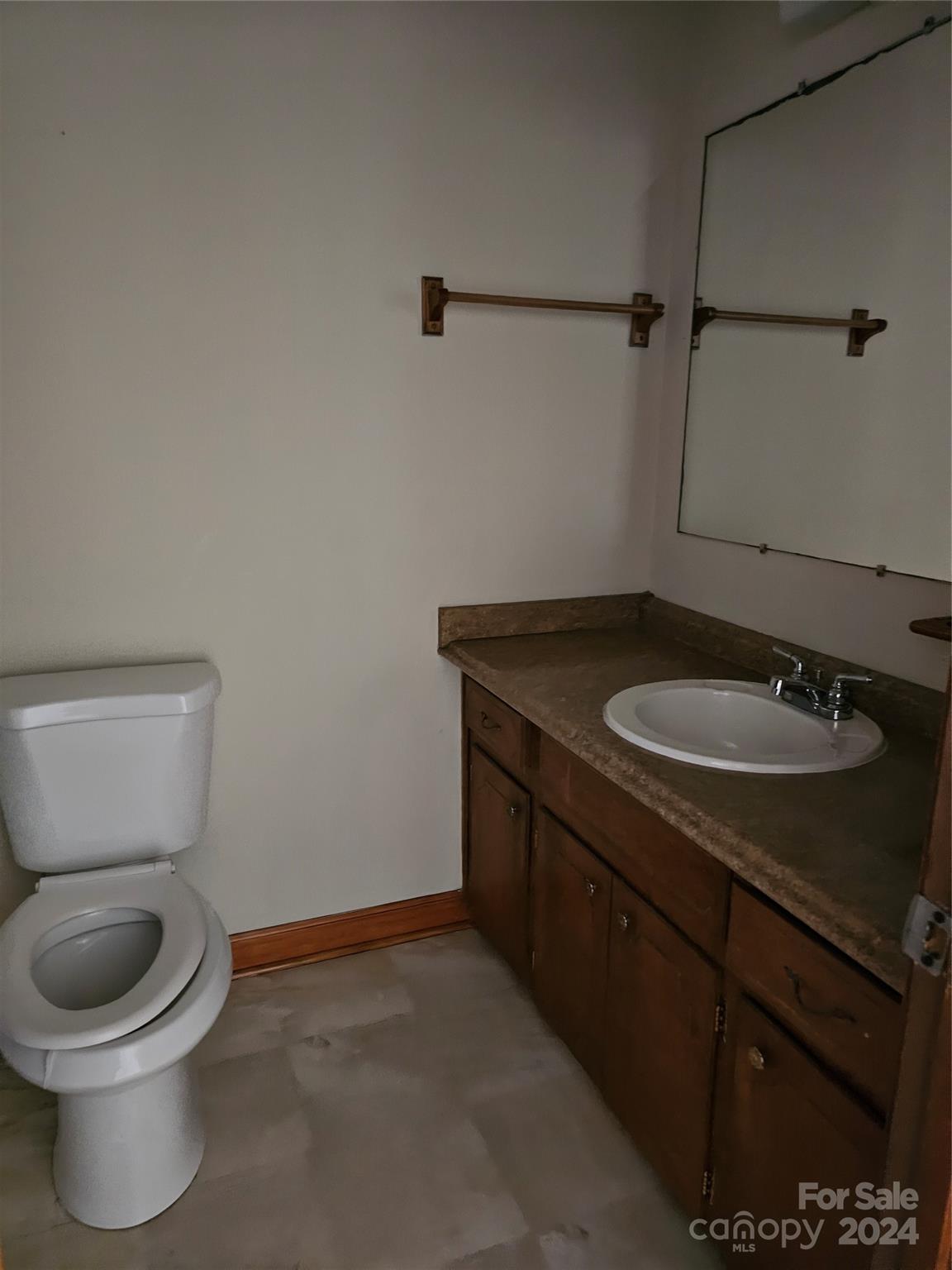 2702 University Drive Lancaster, SC 29720 - Photo 17 of 17 a bathroom with a granite countertop toilet sink and mirror