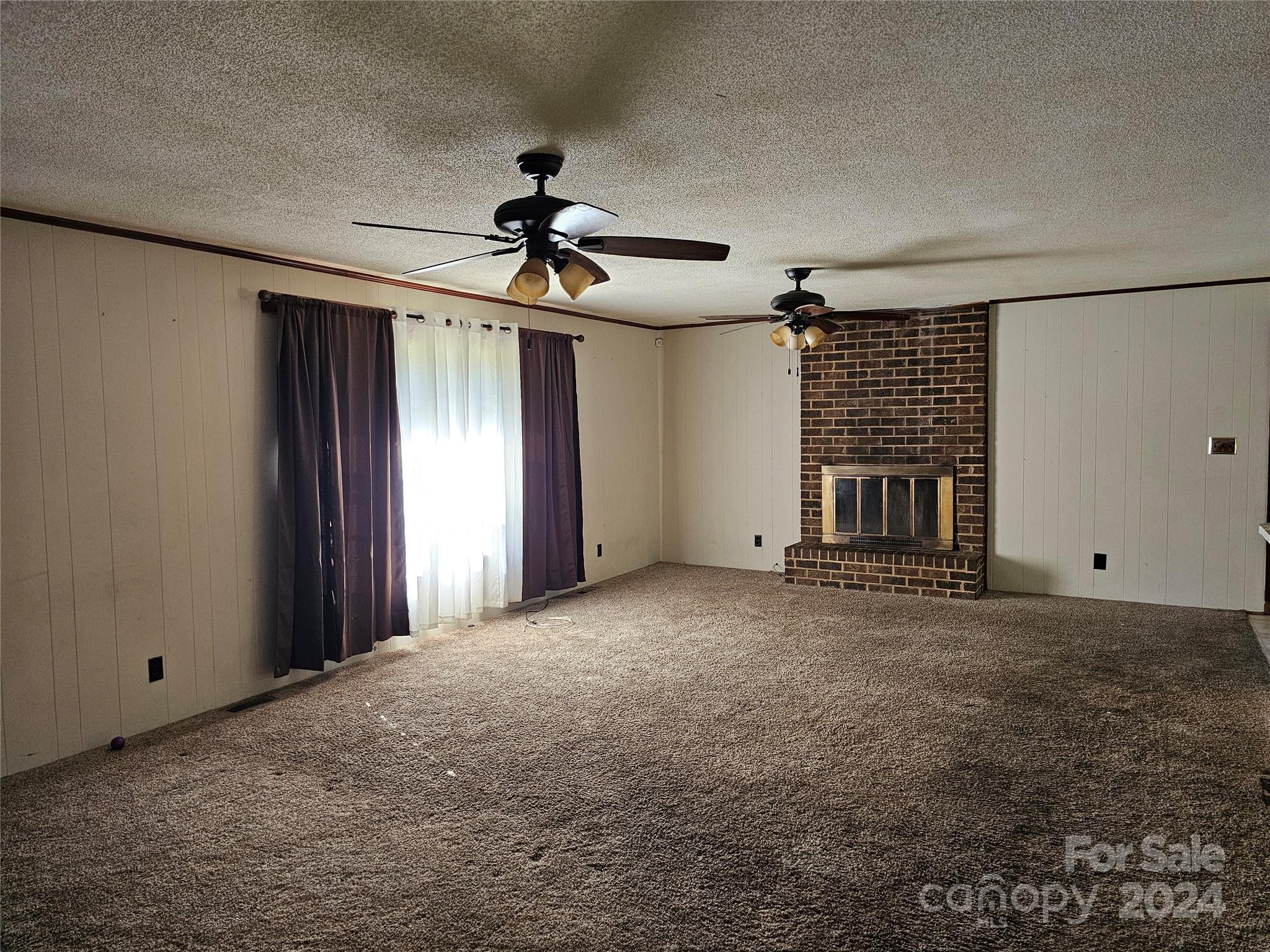 2702 University Drive Lancaster, SC 29720 - Photo 5 of 17 a view of a livingroom with a ceiling fan and window