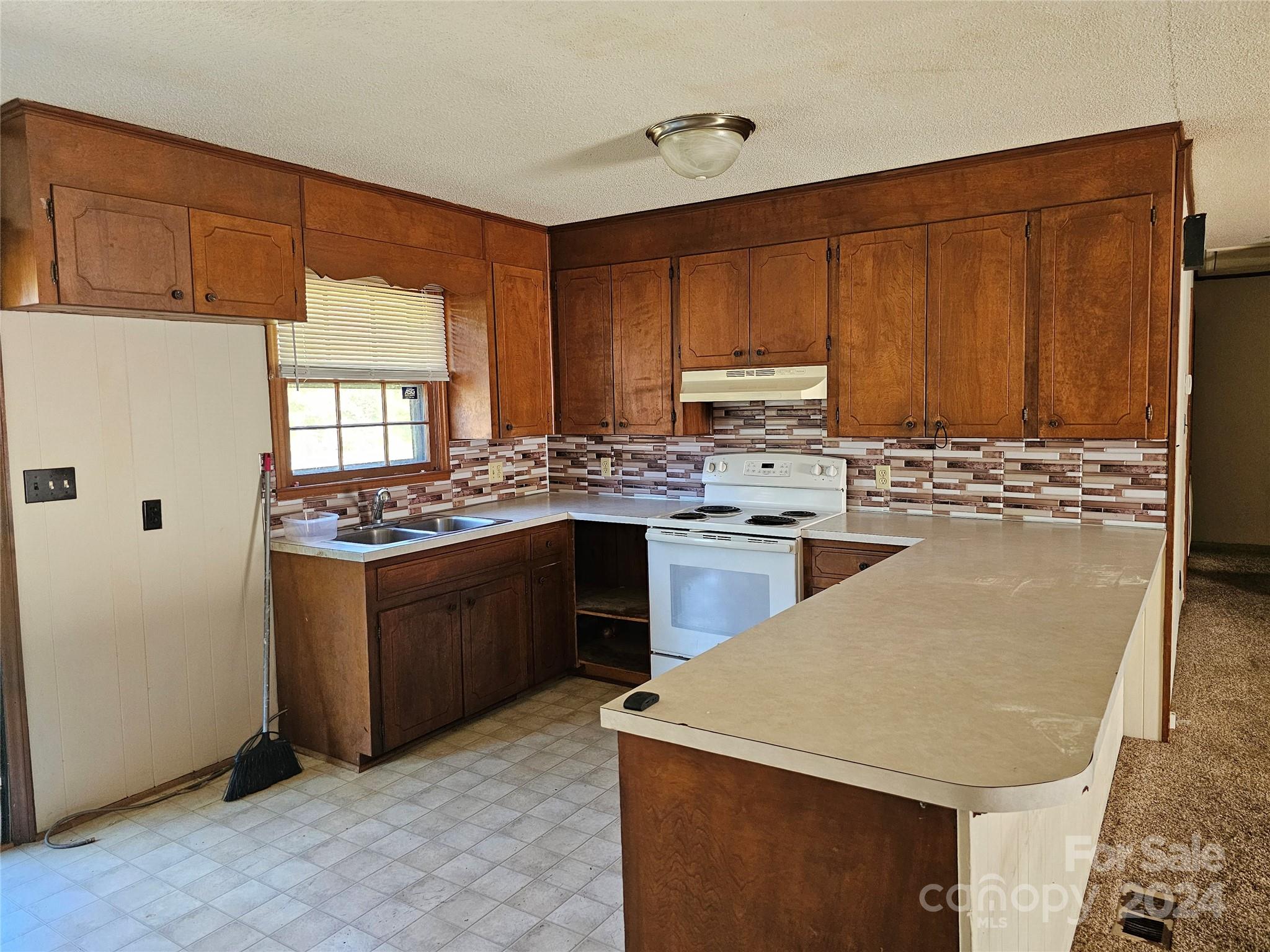2702 University Drive Lancaster, SC 29720 - Photo 7 of 17 a kitchen with stainless steel appliances granite countertop a sink stove and refrigerator