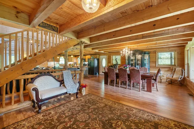 a living room with lots of furniture and a chandelier