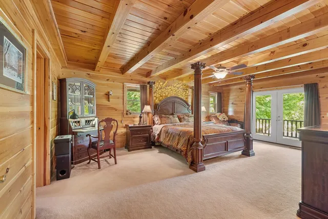 a bedroom with a bed couch and a window