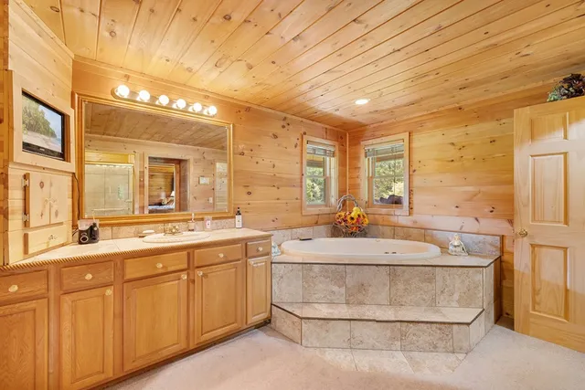 a spacious bathroom with a sink and a mirror