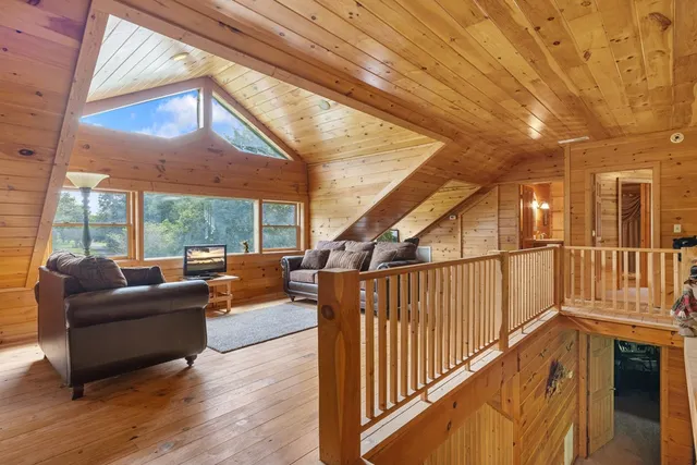a balcony with furniture and wooden floor