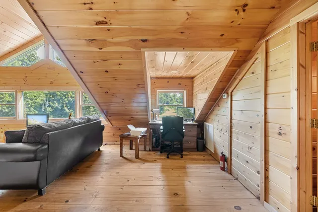 a balcony with furniture and wooden floor