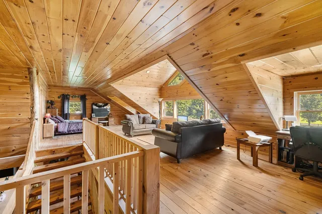 a living room with wooden floor and furniture