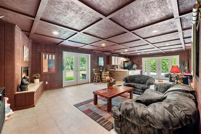 a large white kitchen with a large window and stainless steel appliances