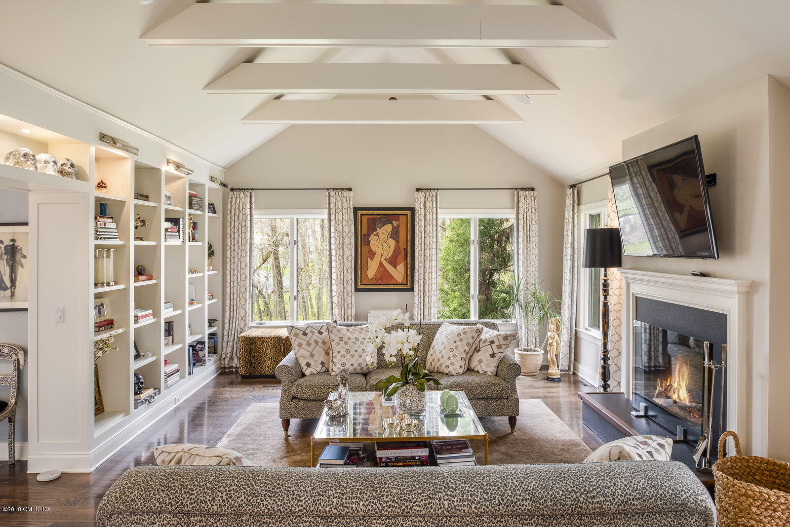 a living room with furniture fireplace and flat screen tv