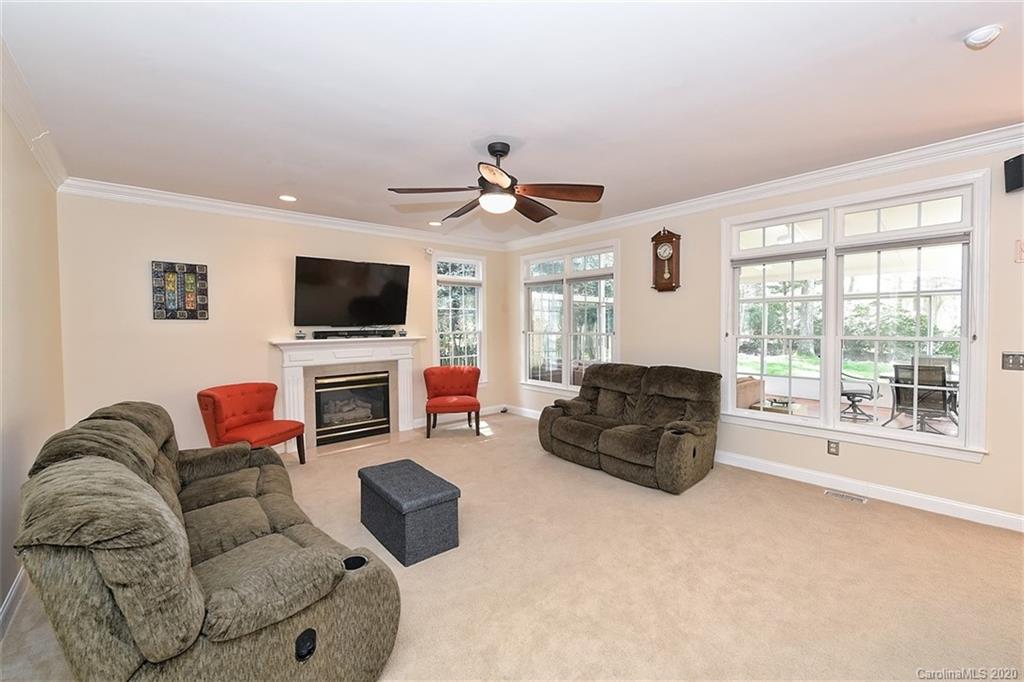 3330 Rhett Butler Place Charlotte, NC 28270 - Photo 15 of 48 a living room with furniture a flat screen tv and a fireplace