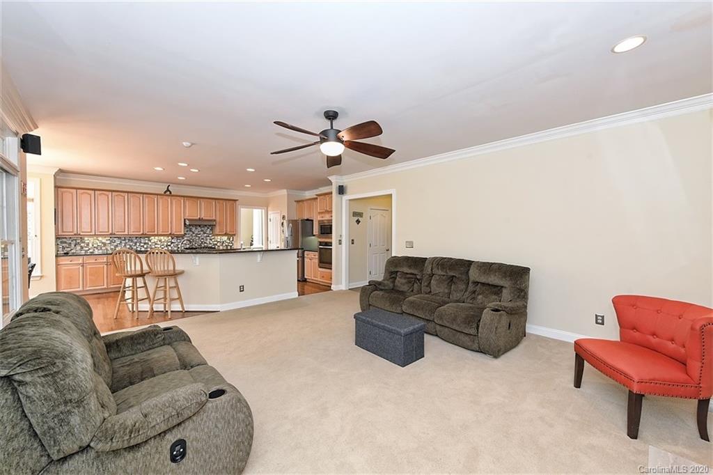 3330 Rhett Butler Place Charlotte, NC 28270 - Photo 17 of 48 a living room with furniture kitchen view and a chandelier