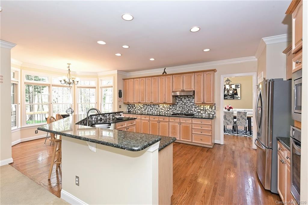 3330 Rhett Butler Place Charlotte, NC 28270 - Photo 19 of 48 a kitchen with stainless steel appliances granite countertop a sink stove and refrigerator