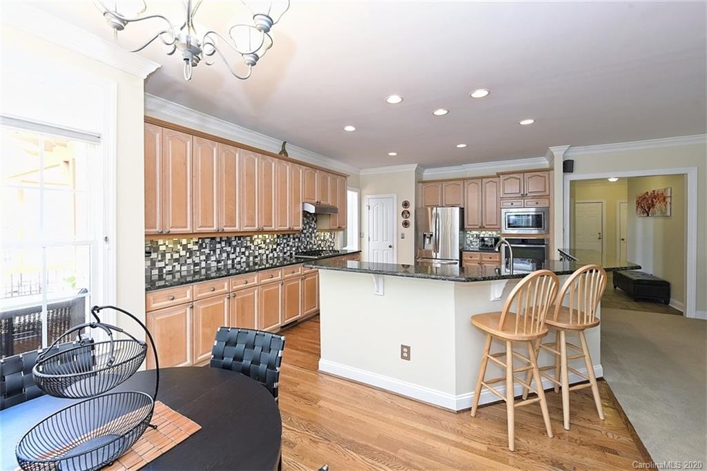 3330 Rhett Butler Place Charlotte, NC 28270 - Photo 21 of 48 a living room with stainless steel appliances furniture and a wooden floor