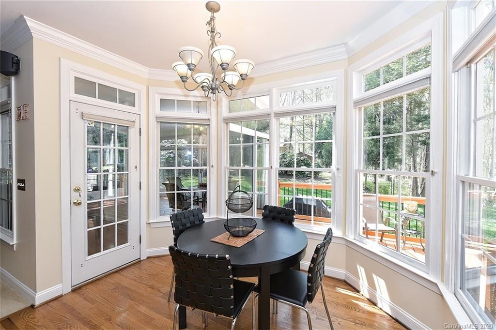 3330 Rhett Butler Place Charlotte, NC 28270 - Photo 22 of 48 a view of a dining room with furniture large windows and wooden floor