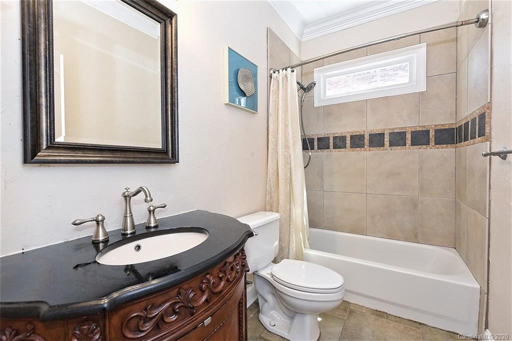 3330 Rhett Butler Place Charlotte, NC 28270 - Photo 24 of 48 a bathroom with a granite countertop sink toilet a mirror and bathtub