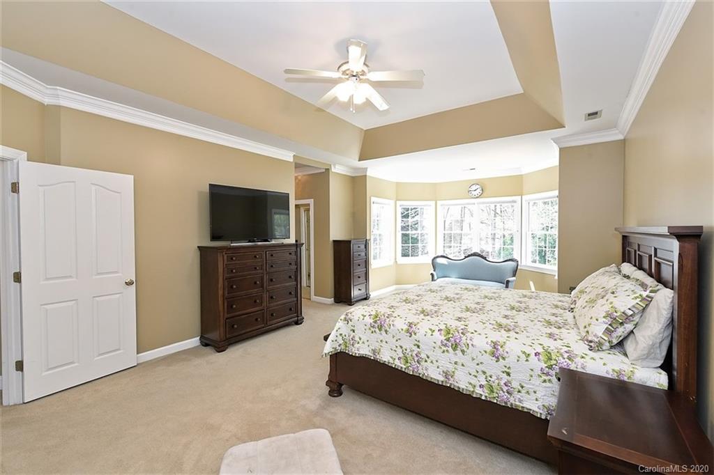 3330 Rhett Butler Place Charlotte, NC 28270 - Photo 27 of 48 a bedroom with a bed and a flat screen tv
