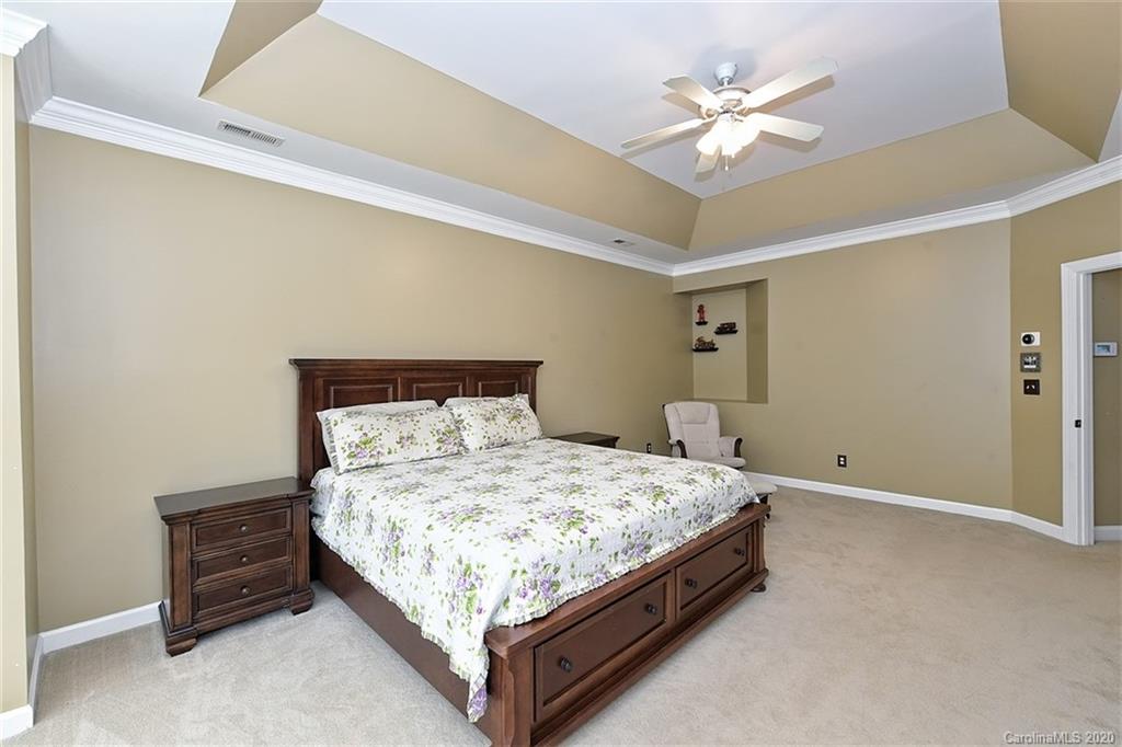 3330 Rhett Butler Place Charlotte, NC 28270 - Photo 28 of 48 a bedroom with a bed and a ceiling fan