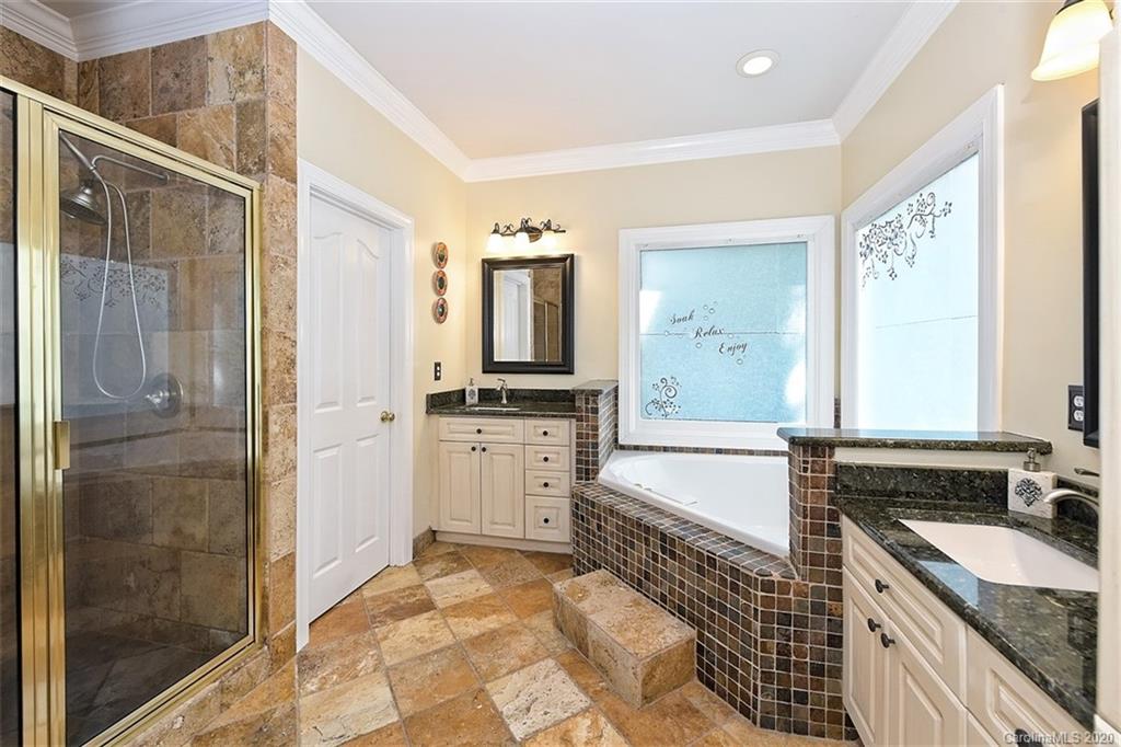 3330 Rhett Butler Place Charlotte, NC 28270 - Photo 30 of 48 a large bathroom with a granite countertop tub sink shower and mirror