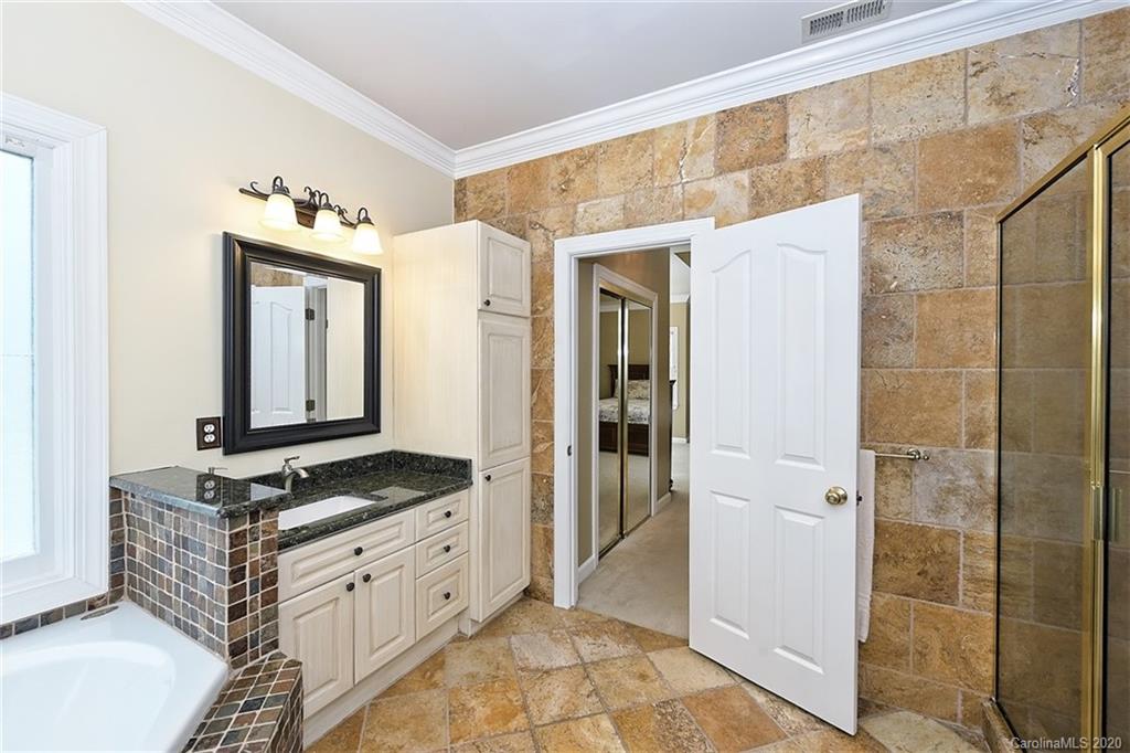 3330 Rhett Butler Place Charlotte, NC 28270 - Photo 32 of 48 a spacious bathroom with a granite countertop sink and a mirror