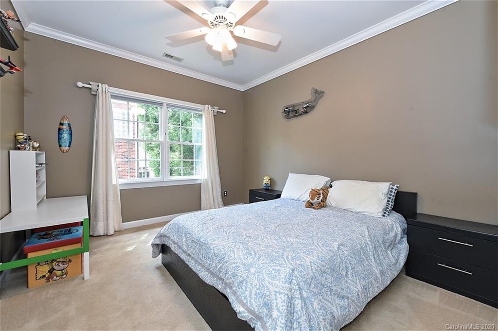 3330 Rhett Butler Place Charlotte, NC 28270 - Photo 33 of 48 a bedroom with a bed and a chandelier