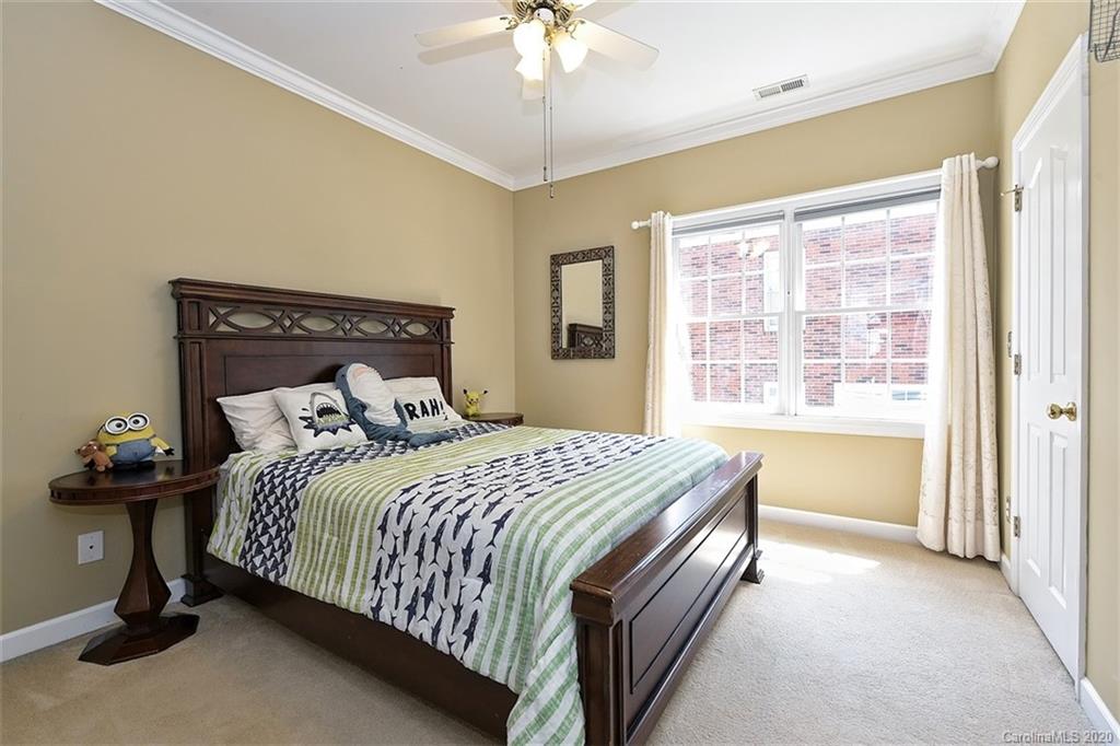 3330 Rhett Butler Place Charlotte, NC 28270 - Photo 34 of 48 a bedroom with a bed and a chandelier