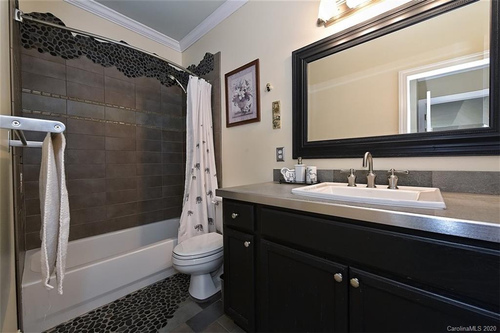 3330 Rhett Butler Place Charlotte, NC 28270 - Photo 35 of 48 a bathroom with a sink a toilet a glass door a shower and a mirror