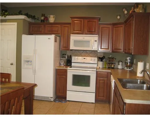 a kitchen with a refrigerator sink and stove