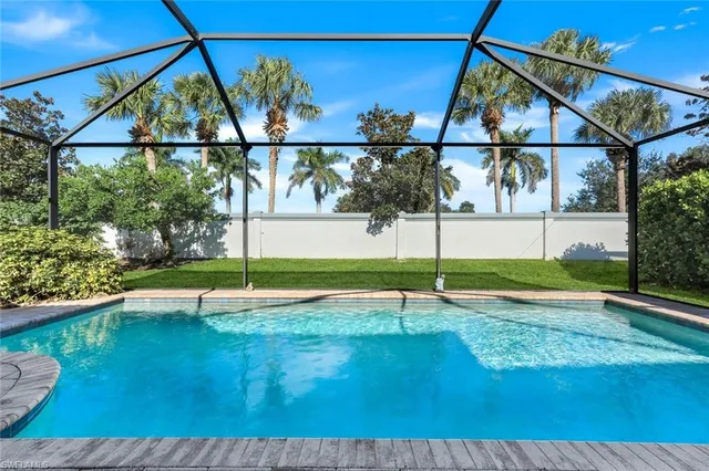 a view of pool with a yard