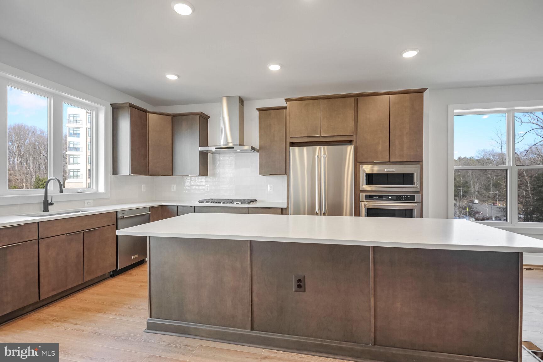 1653 Fellowship Square Reston, VA 20190 - Photo 1 of 26 a large kitchen with kitchen island a sink stainless steel appliances and cabinets