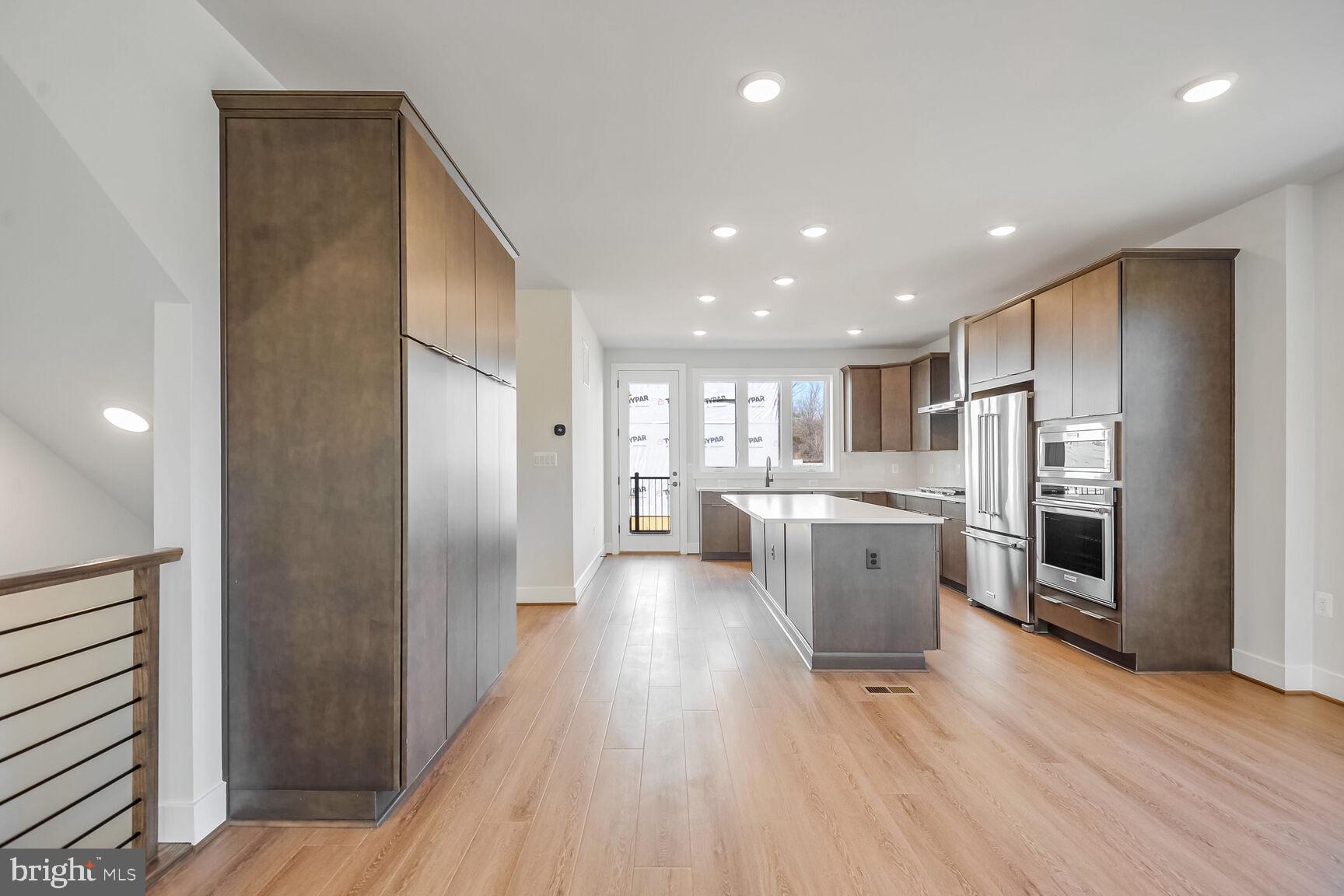 1653 Fellowship Square Reston, VA 20190 - Photo 11 of 26 a kitchen with a refrigerator and a sink