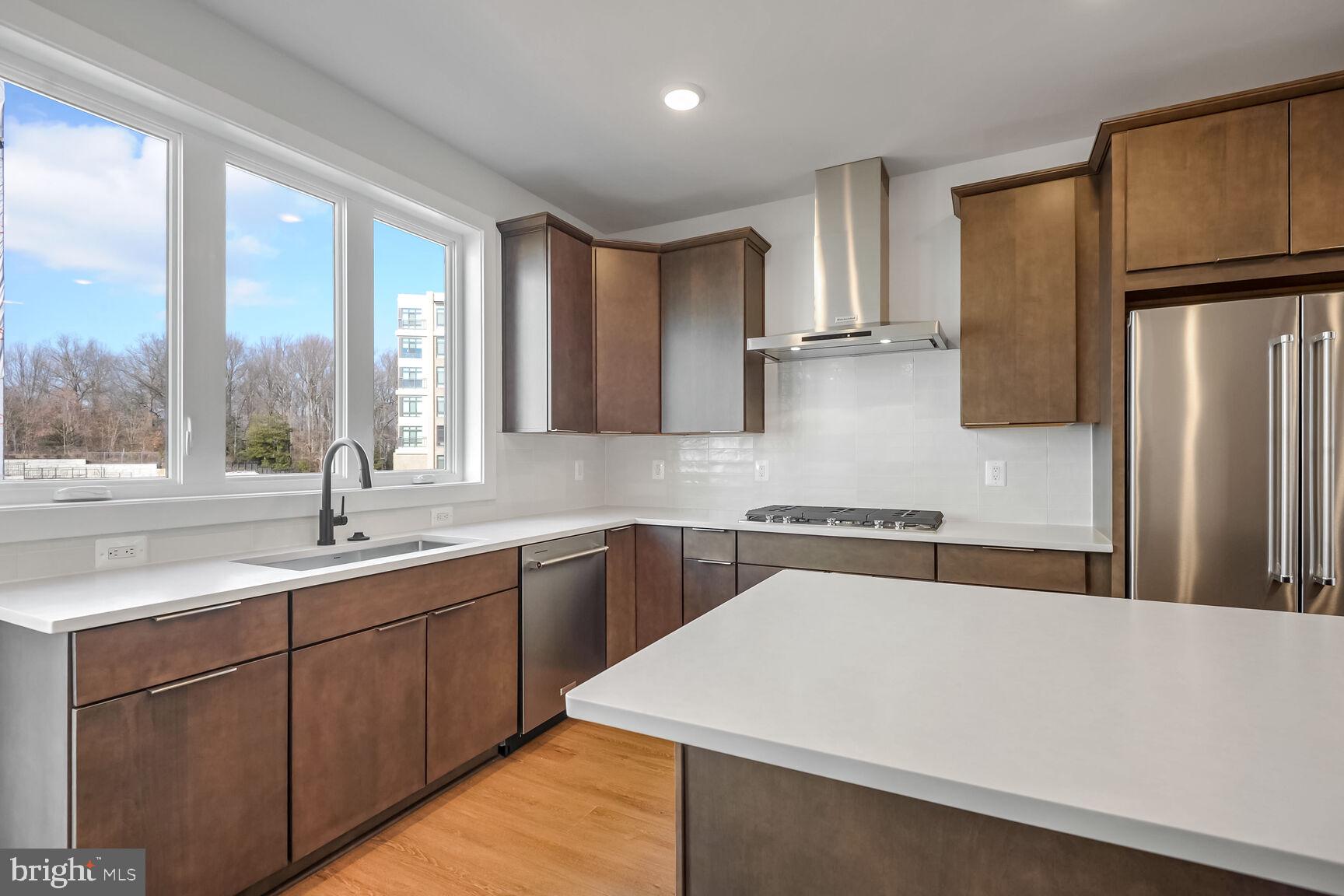 1653 Fellowship Square Reston, VA 20190 - Photo 2 of 26 a kitchen with a sink a refrigerator and window