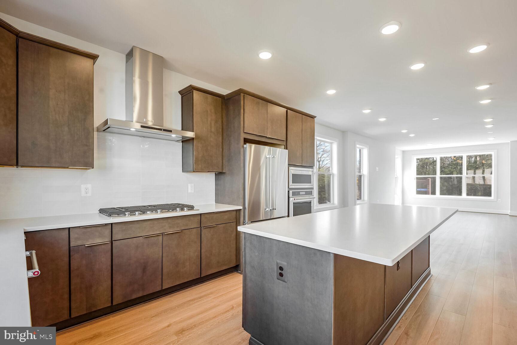 1653 Fellowship Square Reston, VA 20190 - Photo 5 of 26 a large kitchen with stainless steel appliances granite countertop a large counter top a sink and a refrigerator