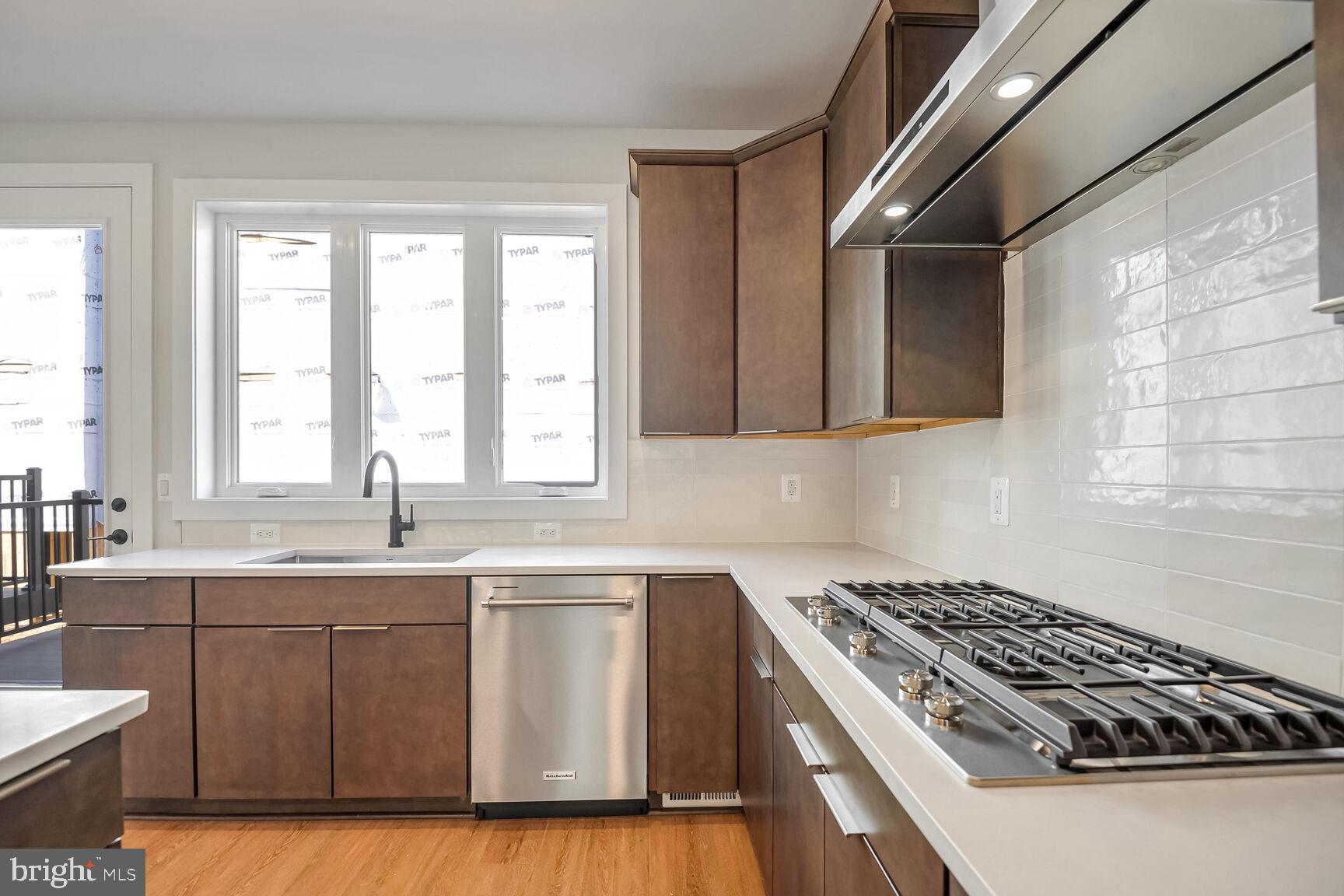 1653 Fellowship Square Reston, VA 20190 - Photo 7 of 26 a kitchen with a sink stove and cabinets