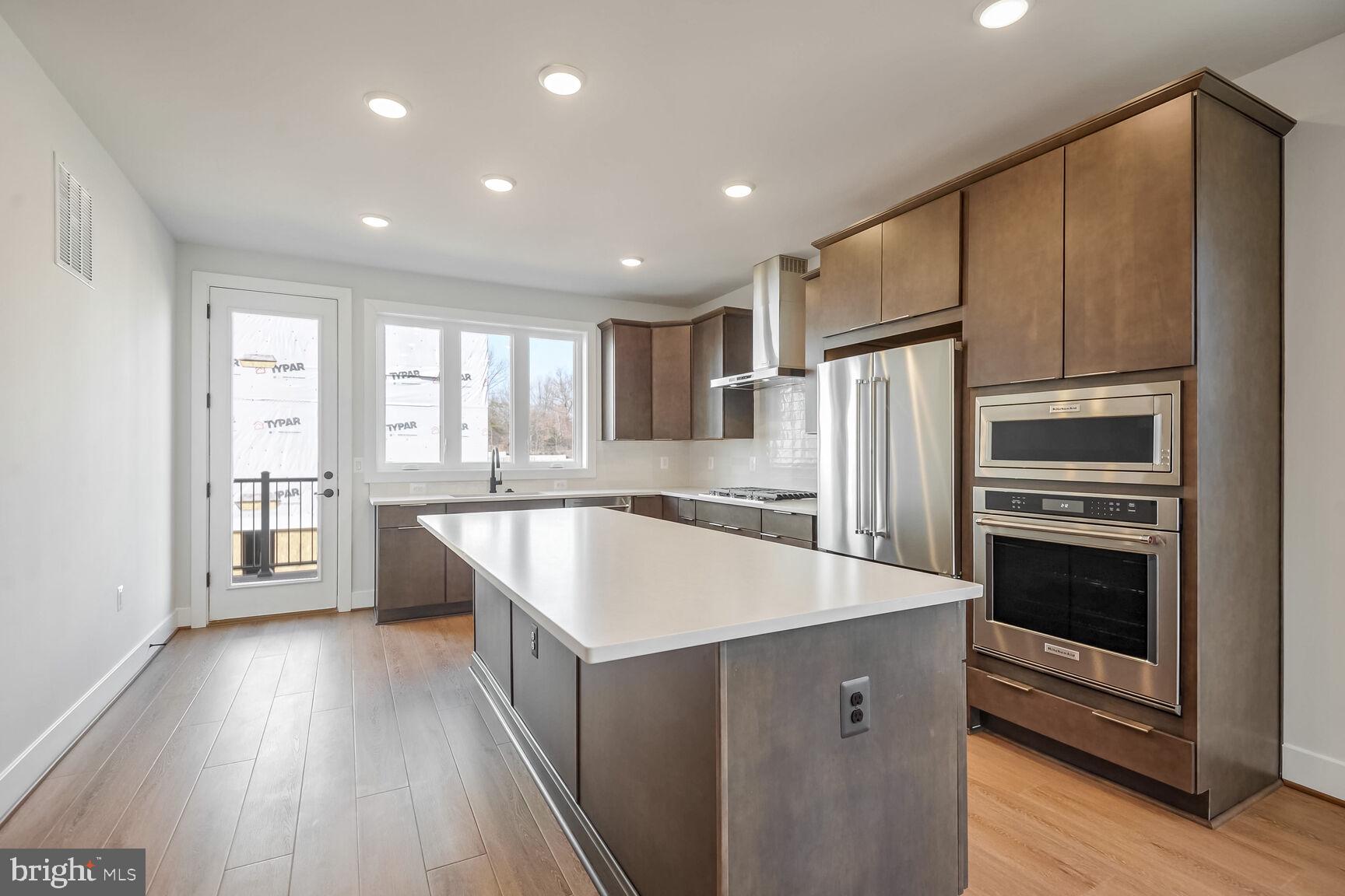 1653 Fellowship Square Reston, VA 20190 - Photo 8 of 26 a kitchen with stainless steel appliances granite countertop a refrigerator a sink and a stove