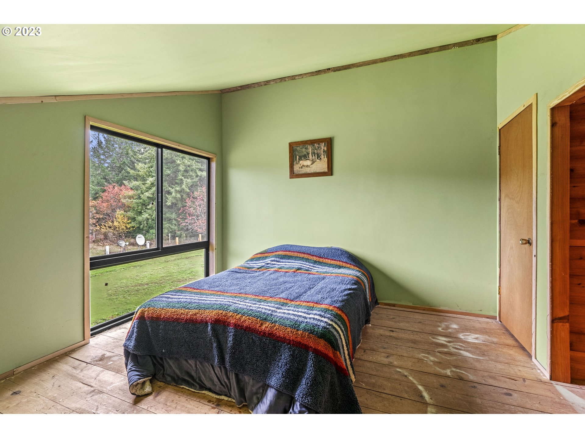 282 Hewitt Road Chehalis, WA 98532 - Photo 18 of 25 a bedroom with a bed and a painting on the wall