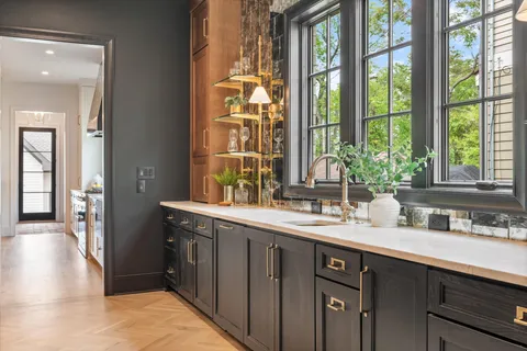 a bathroom with a double vanity sink a mirror a bathtub and shower