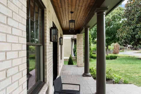 a view of a dining room with furniture wooden floor and chandelier
