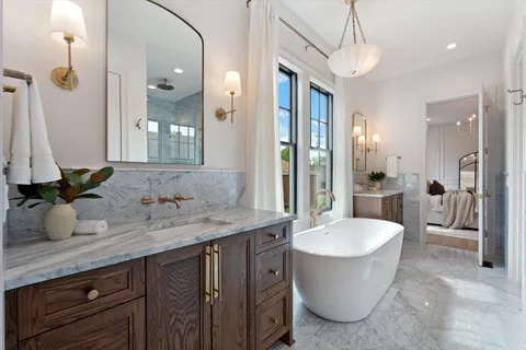 a dining room with furniture a chandelier and wooden floor