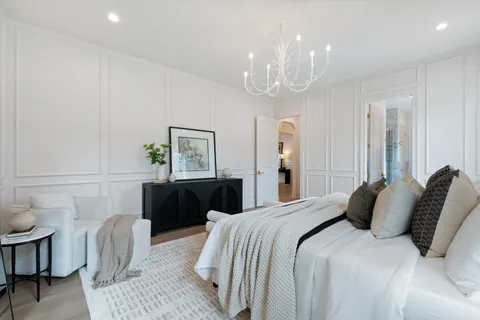a living room with furniture a flat screen tv and kitchen view