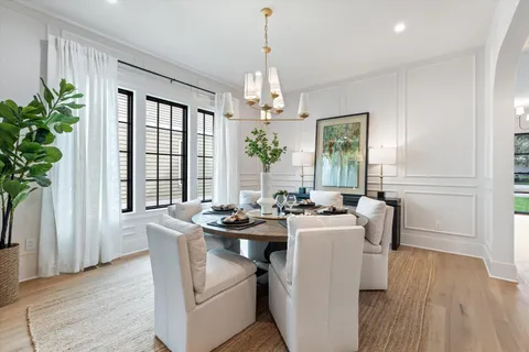 a living room with furniture a chandelier and a window