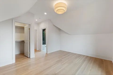 a view of a kitchen with wooden floor and a sink