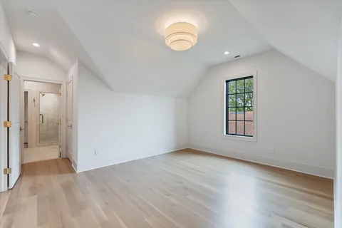 a living room with furniture tv and a potted plant
