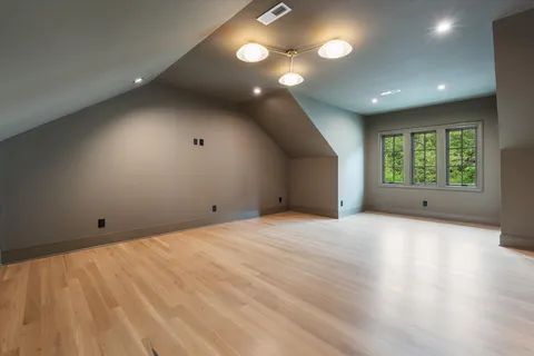 a living room with furniture a fireplace and a large window