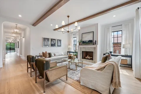 a kitchen with stainless steel appliances granite countertop a stove a sink dishwasher a refrigerator and a dining table with wooden floor