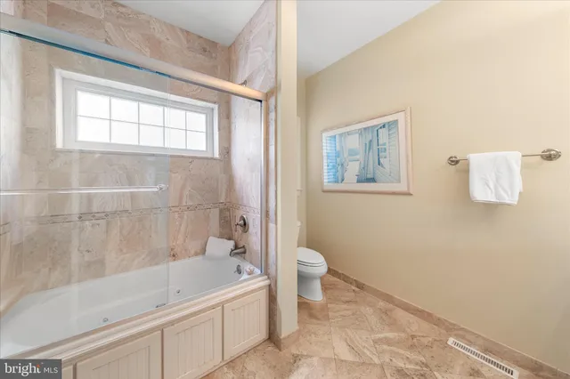 a bedroom with a bed and lamp