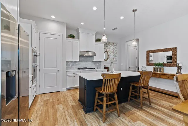 a living room with furniture a flat screen tv and a potted plant