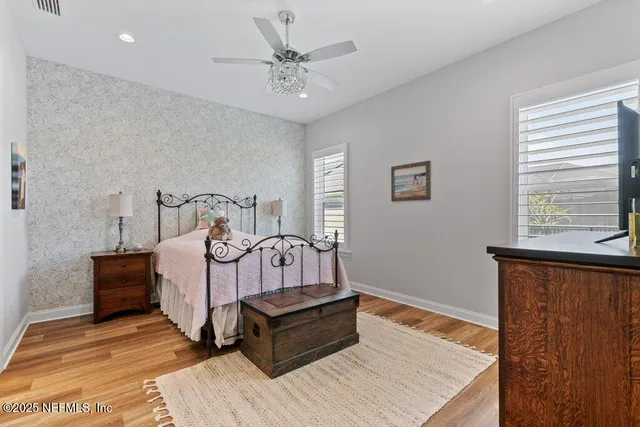 a bathroom with a granite countertop sink mirror vanity and toilet