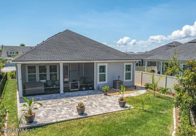 a front view of a house with a yard and palm trees