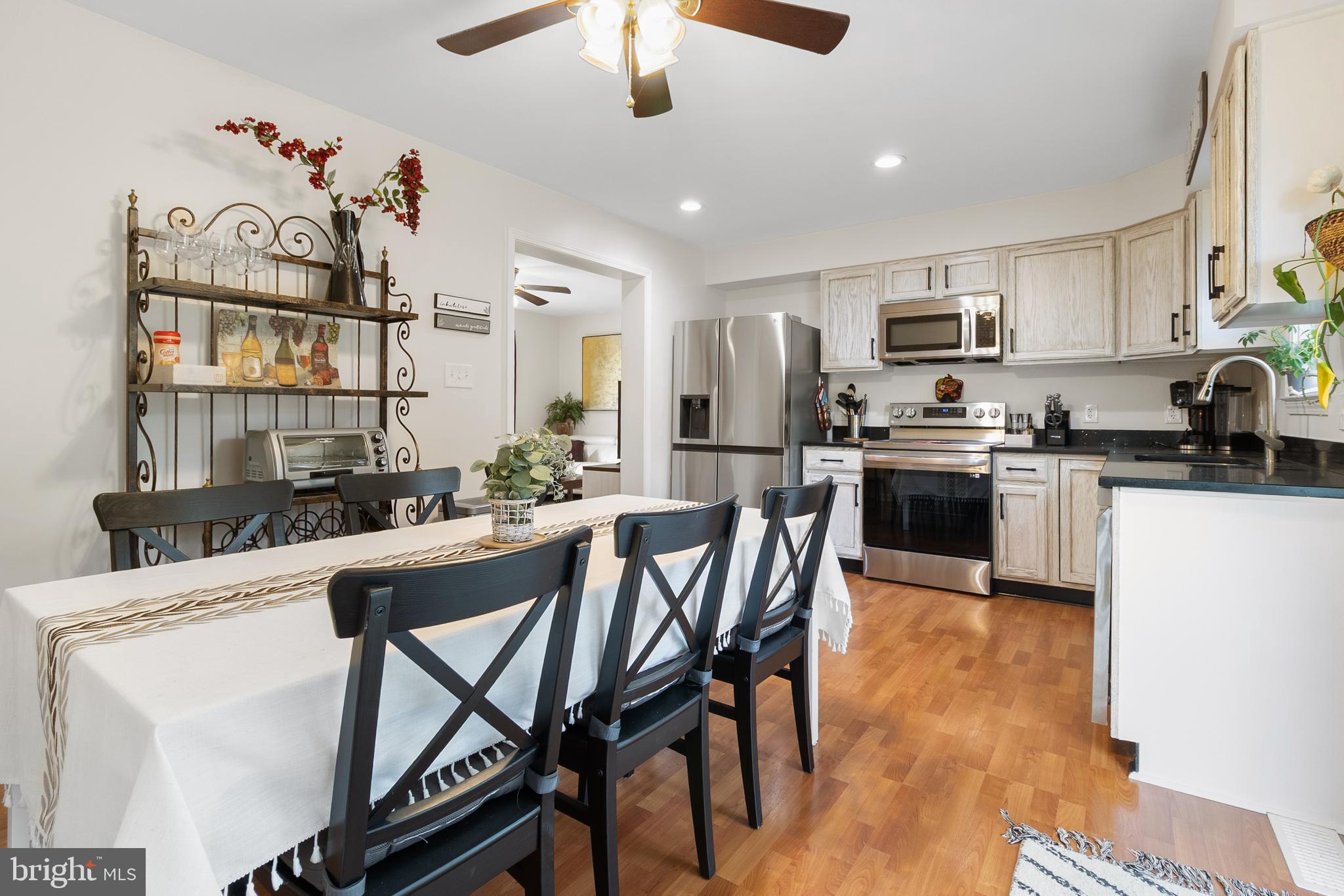 19821 Foggy Bottom Road Bluemont, VA 20135 - Photo 31 of 92 a kitchen with stainless steel appliances kitchen island granite countertop a stove a sink a dining table and chairs